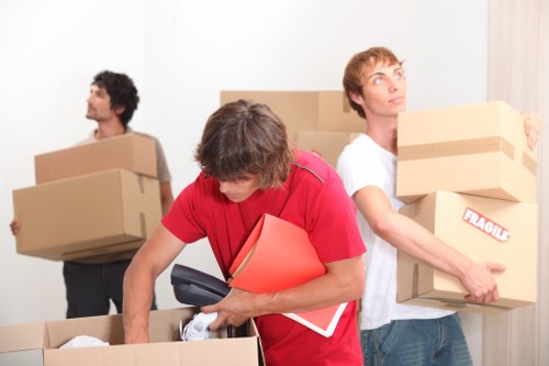 Packed moving boxes and furniture inside a removals vehicle