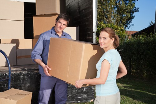 Local removals team handling furniture in East Ham street access